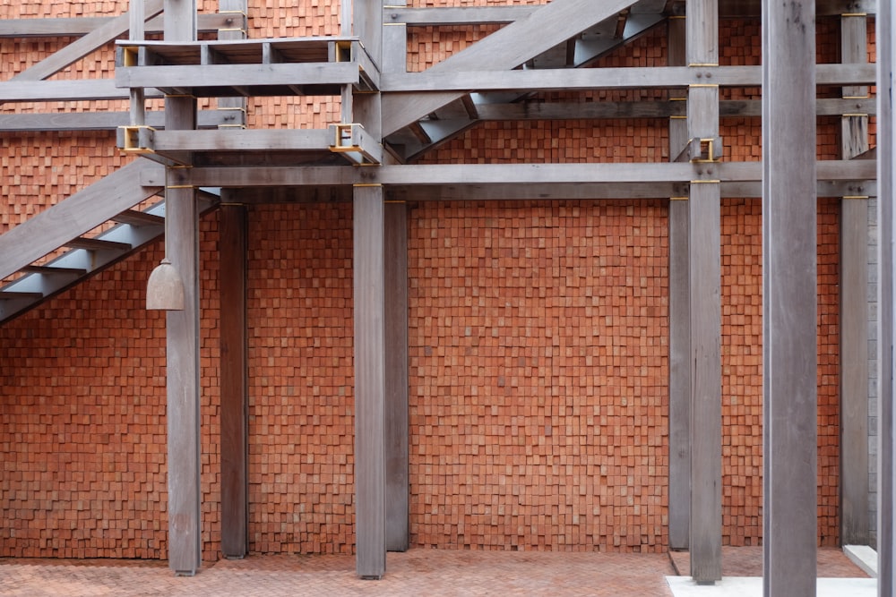 a red brick wall with a metal stair case