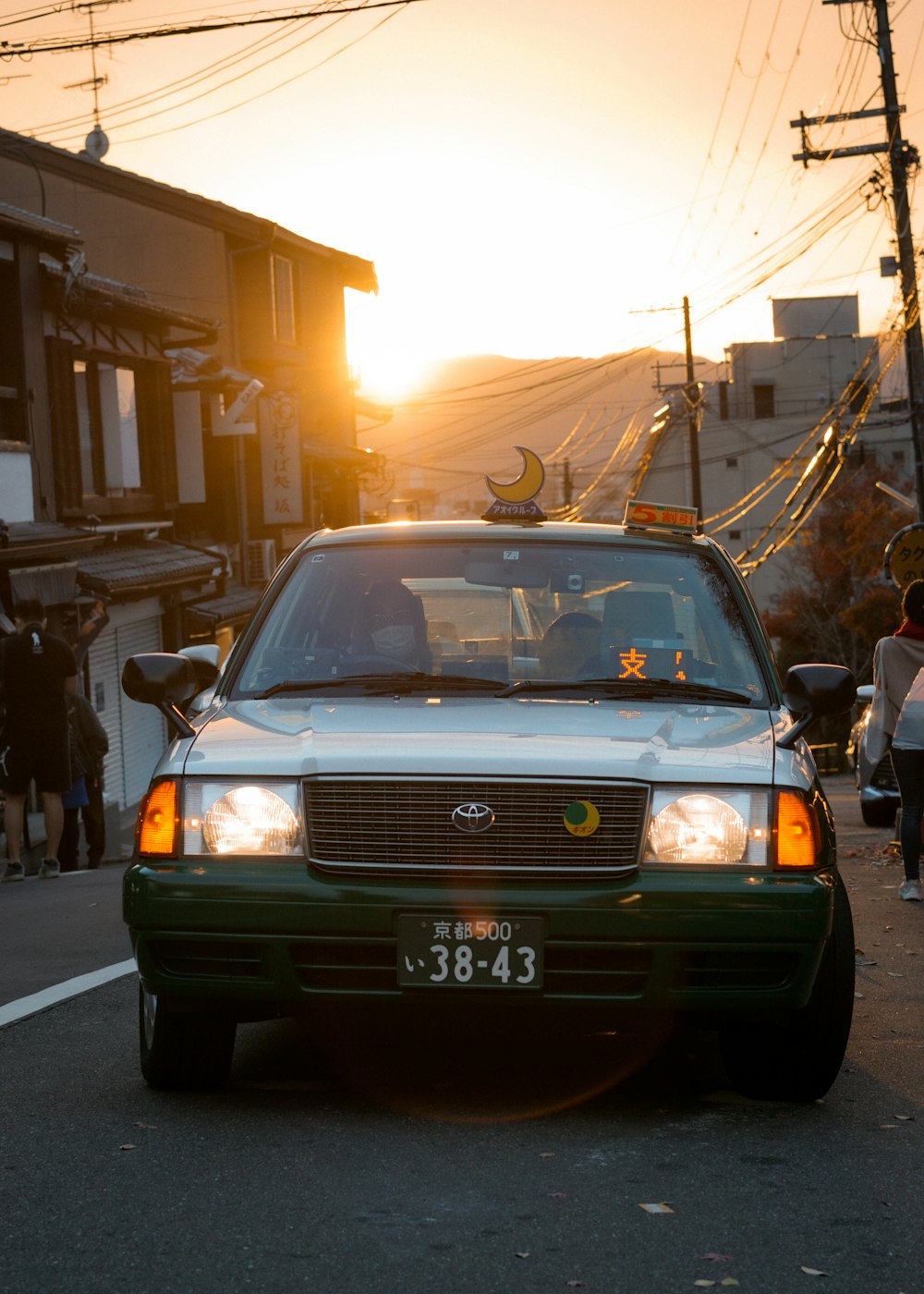 a car driving down a street at sunset