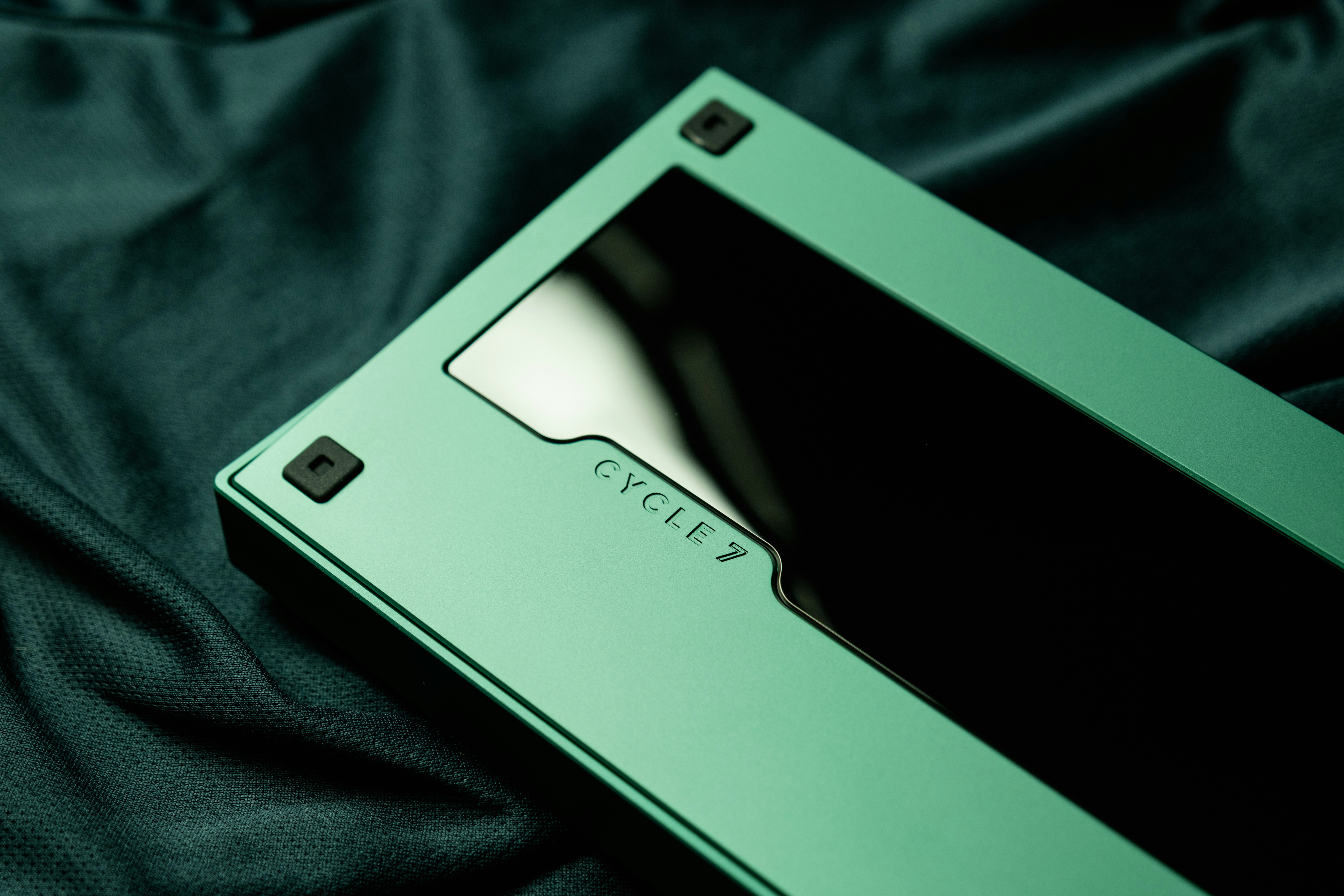 a close up of a green card on a black cloth