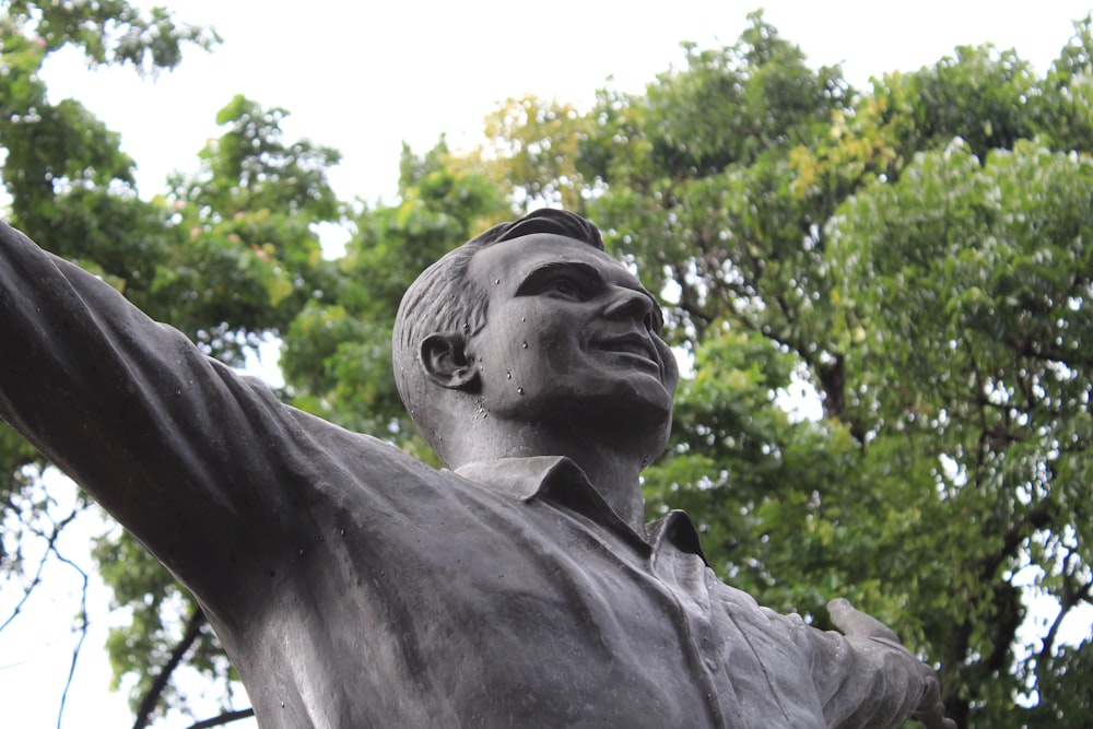 a close up of a statue of a man with his arm in the air