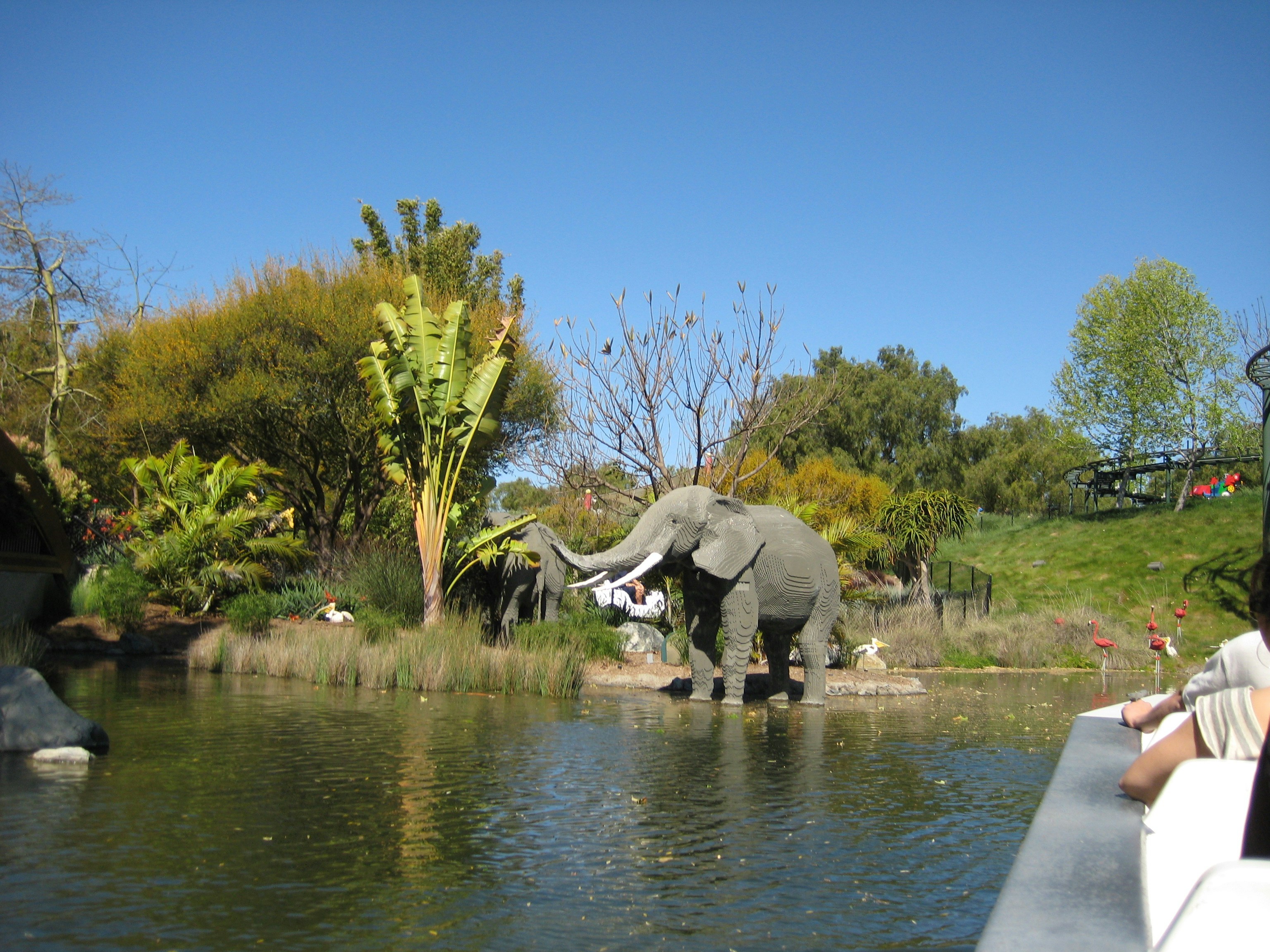 an elephant walking across a body of water, Elephant statue in an amusement part