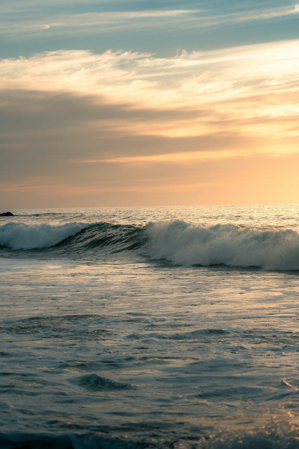 a person riding a surfboard on a wave in the ocean