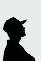 a silhouette of a man wearing a hat