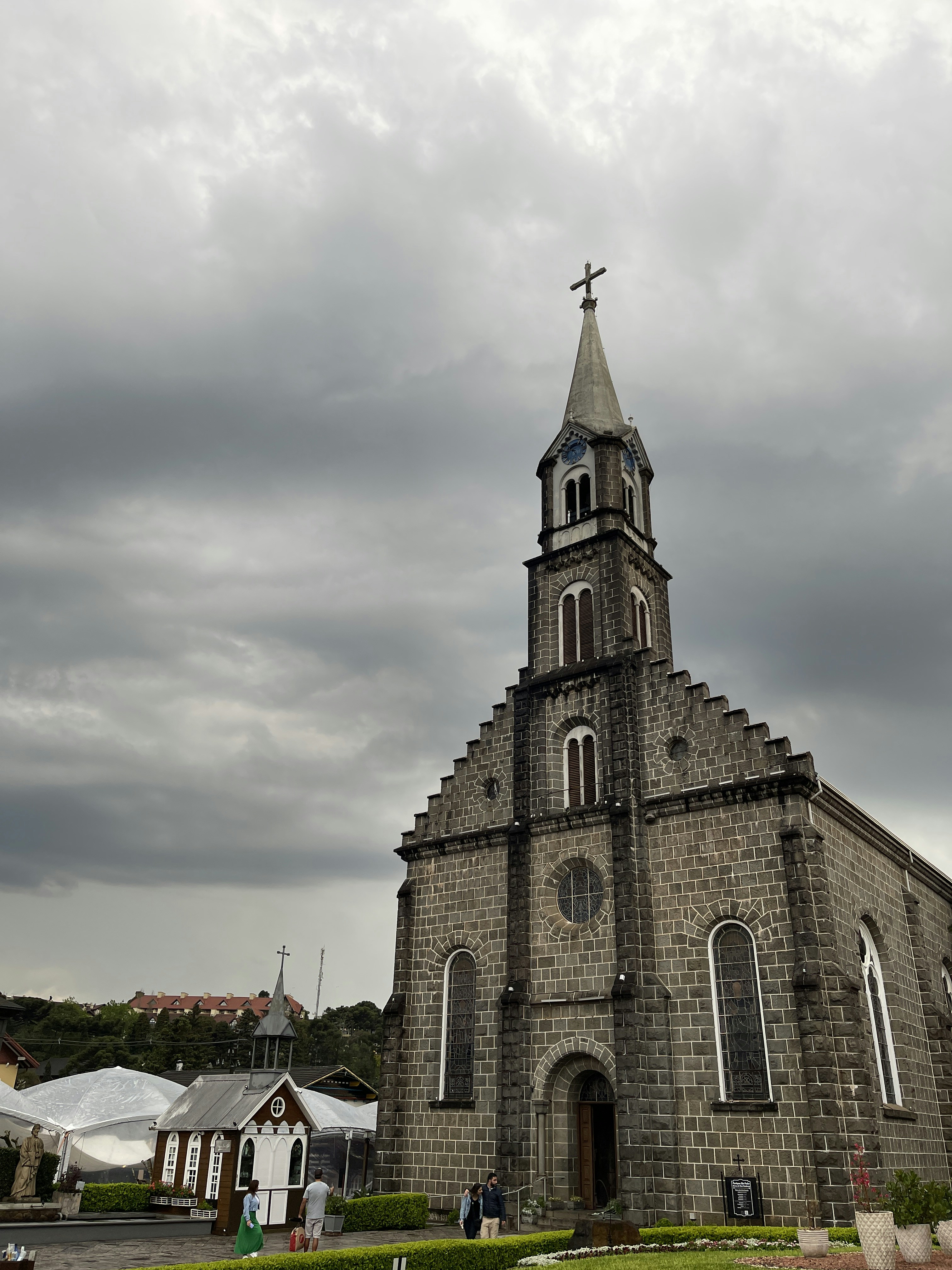 an old church with a steeple on a cloudy day