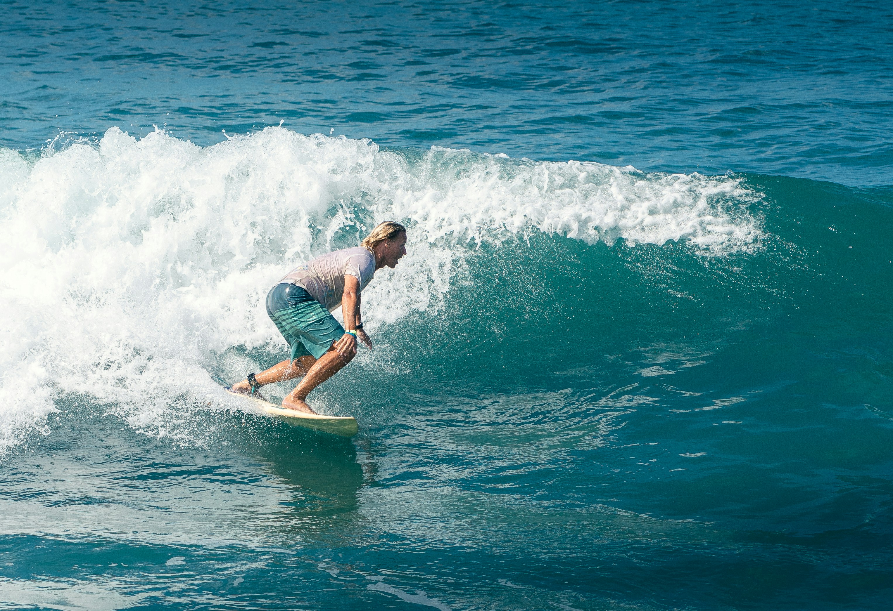 a man riding a wave on top of a surfboard