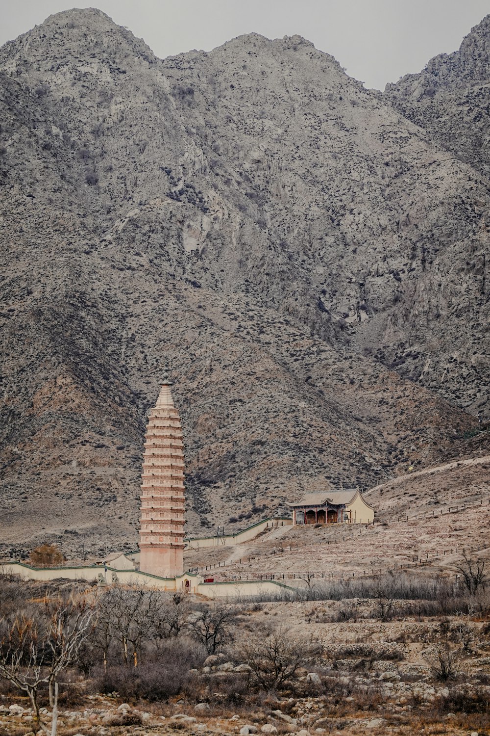 a tall tower sitting in the middle of a desert