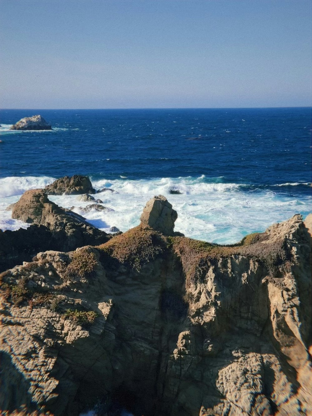 a view of the ocean from a rocky cliff