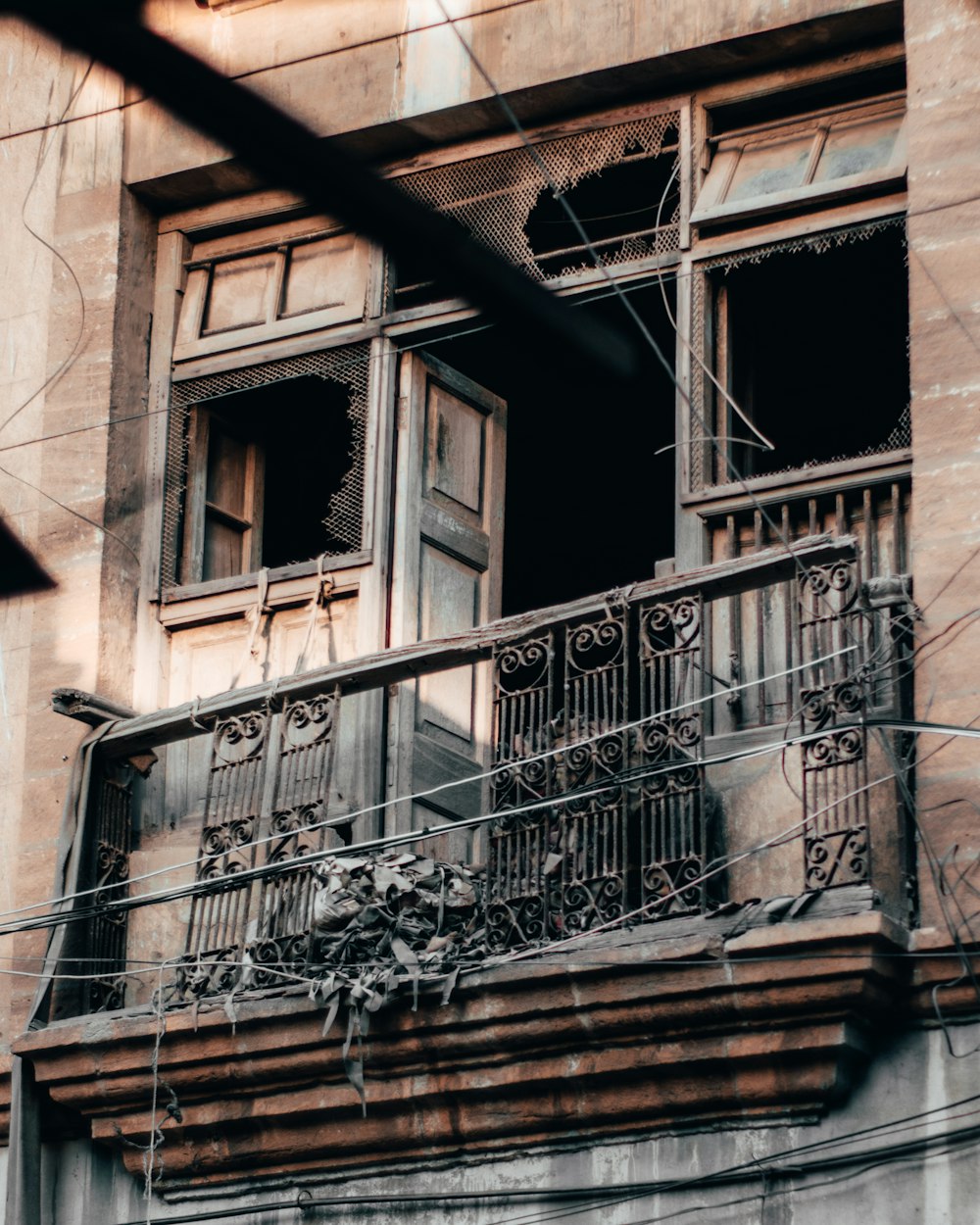 an old building with a balcony and wrought iron railing