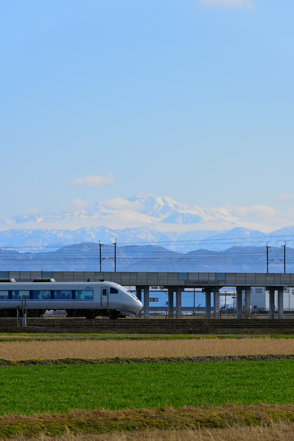 a train traveling down tracks next to a field