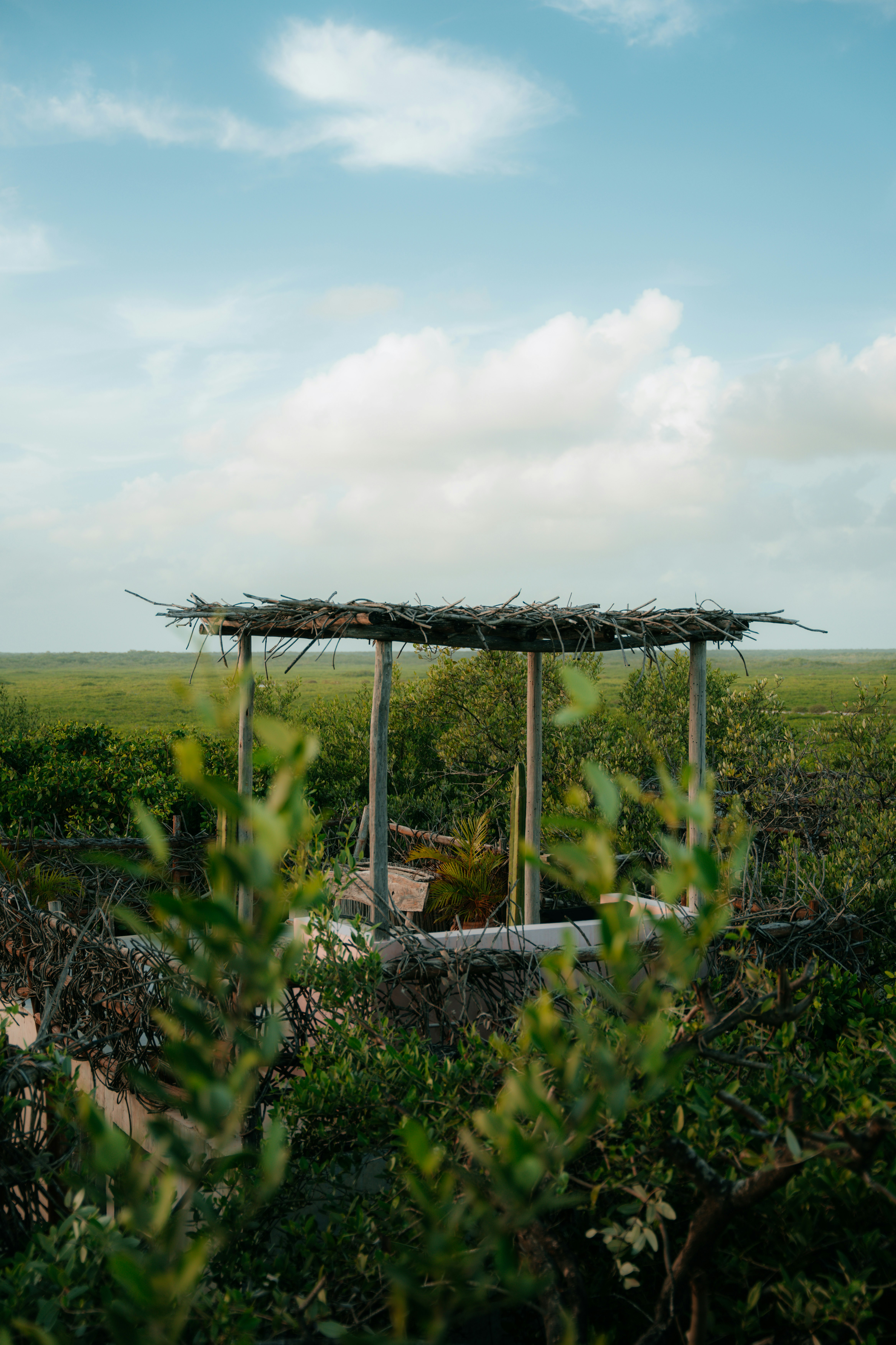 a gazebo in the middle of a green field