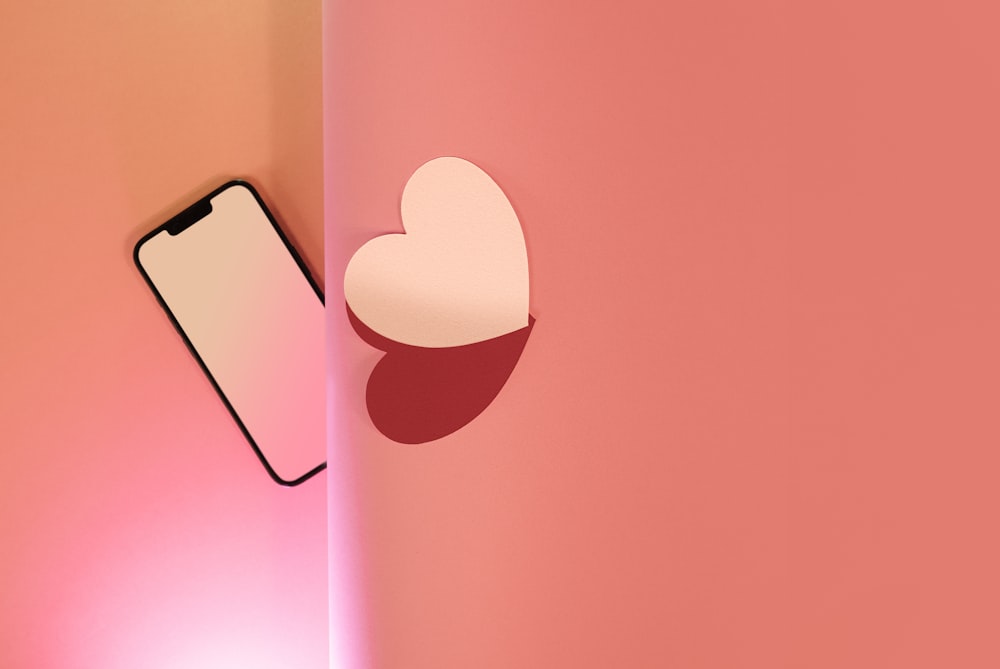 a cell phone with a heart cut out of it