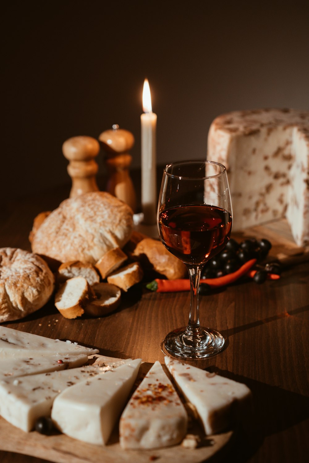 a glass of wine sitting next to a plate of food