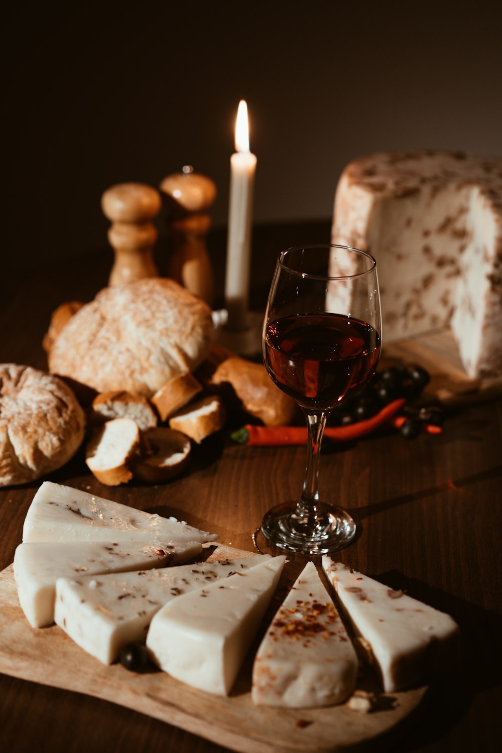 a glass of wine and some bread on a table