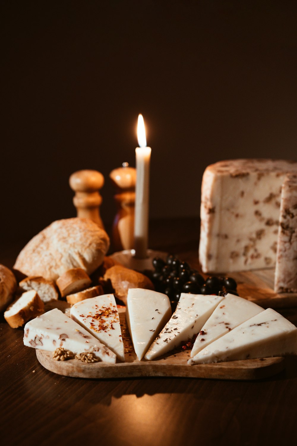 a wooden cutting board topped with lots of cheese