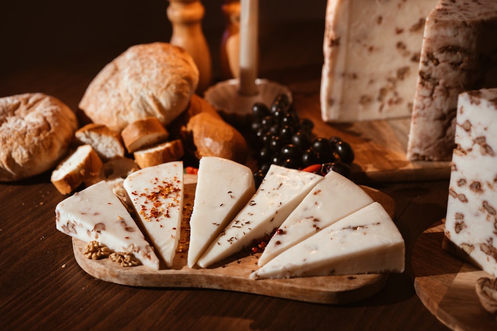 a wooden cutting board topped with lots of cheese