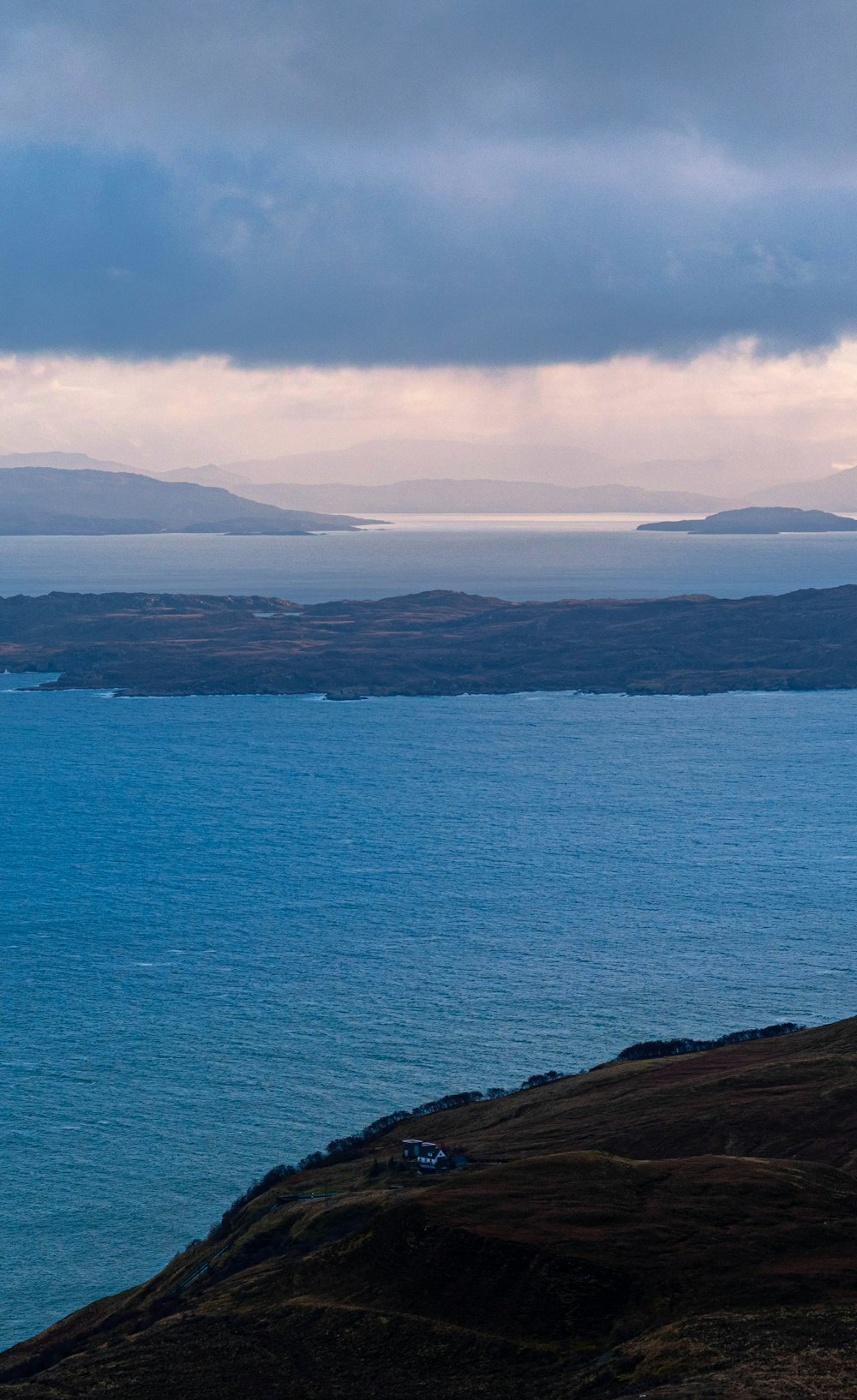 a large body of water sitting under a cloudy sky