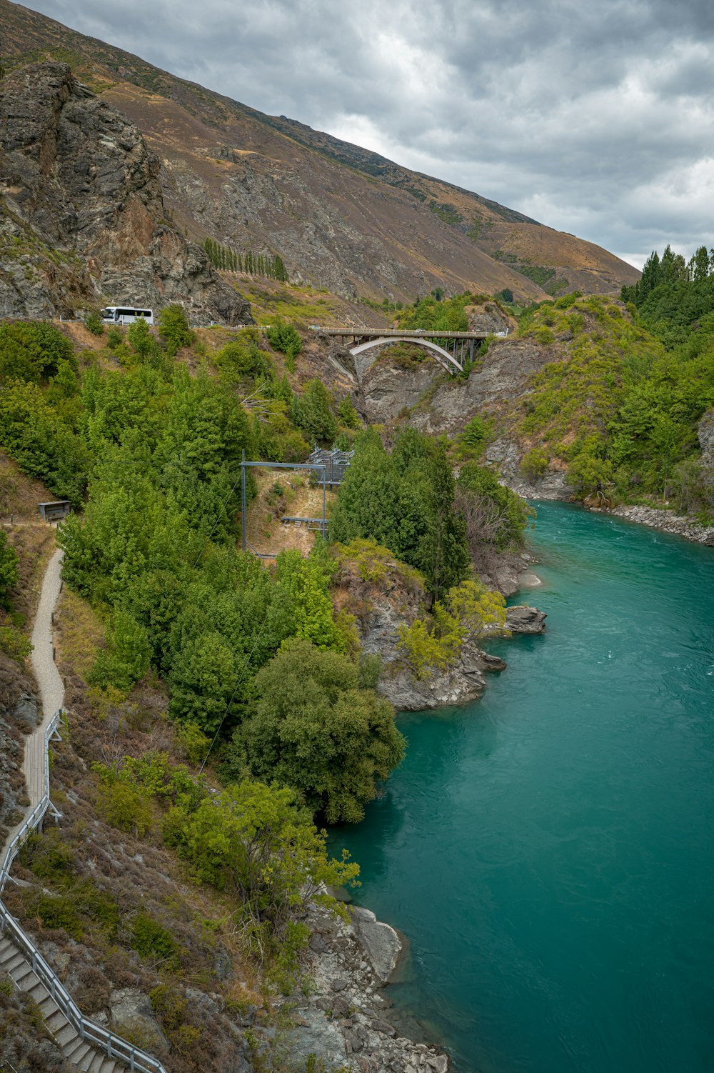 a river running through a lush green hillside