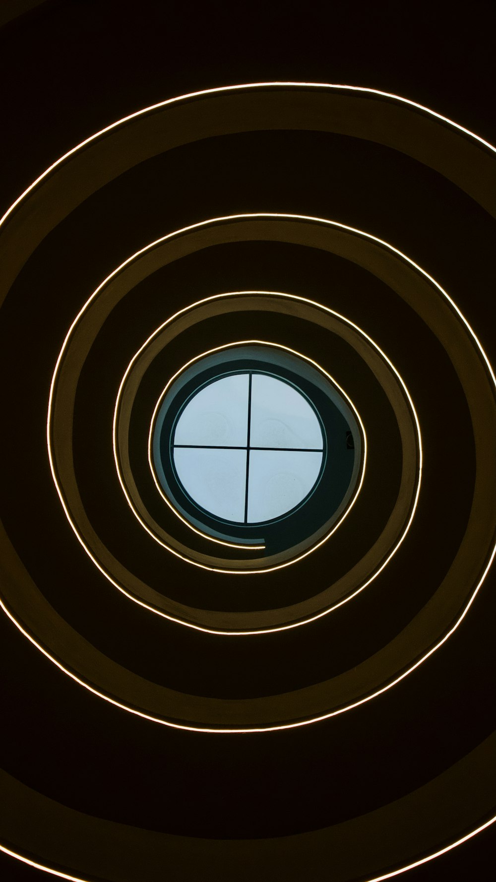 a circular window in a building with a blue sky in the background