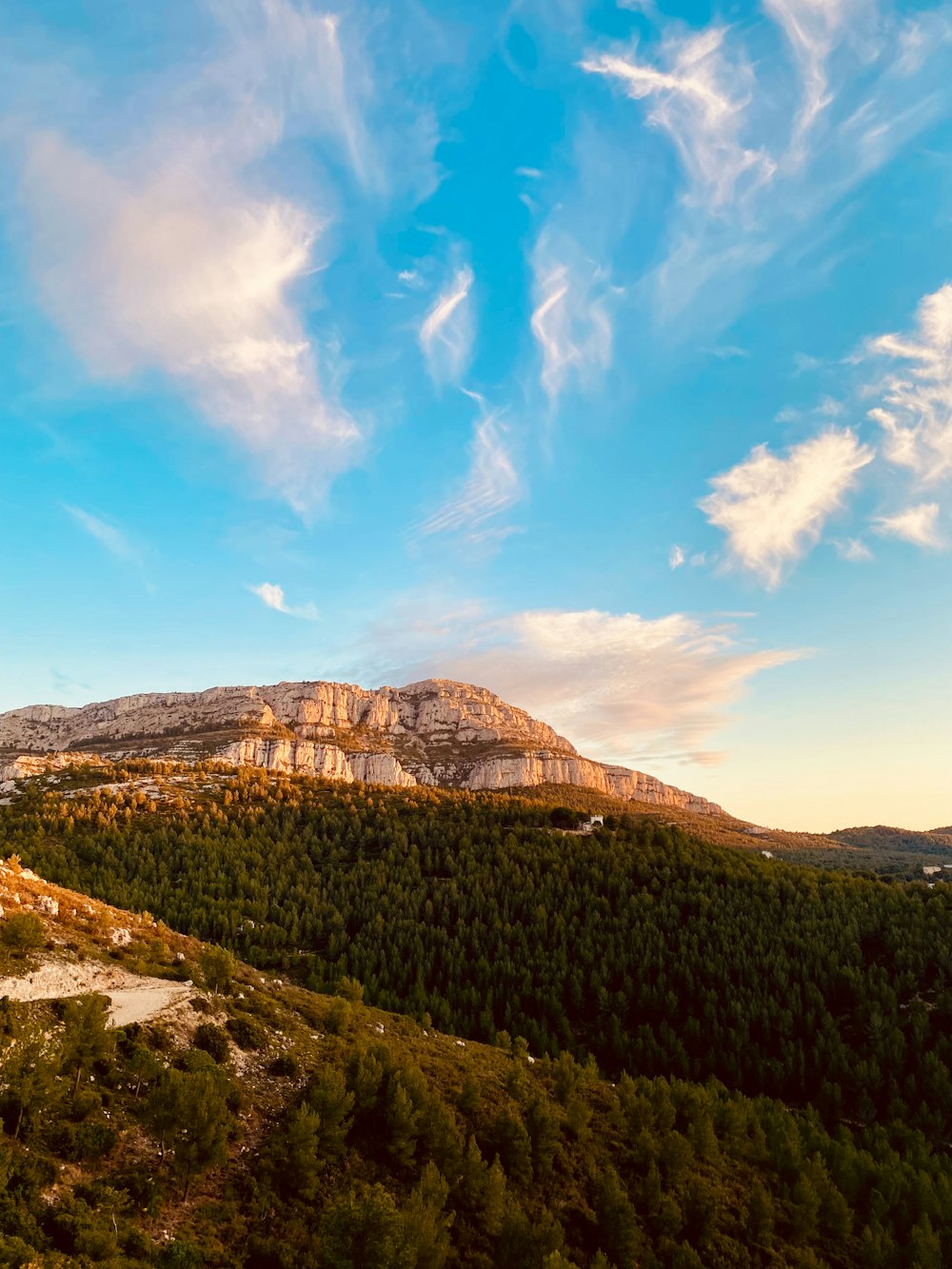 a scenic view of a mountain range with a blue sky