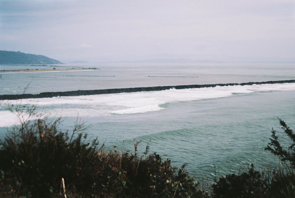 a body of water with waves coming in to shore