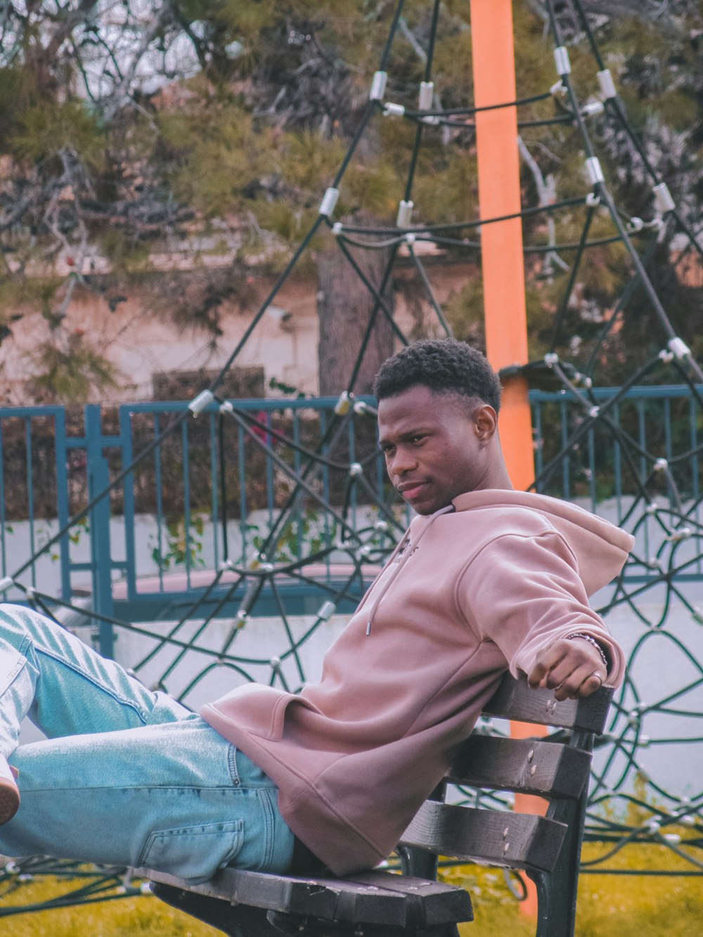 a man sitting on top of a wooden bench