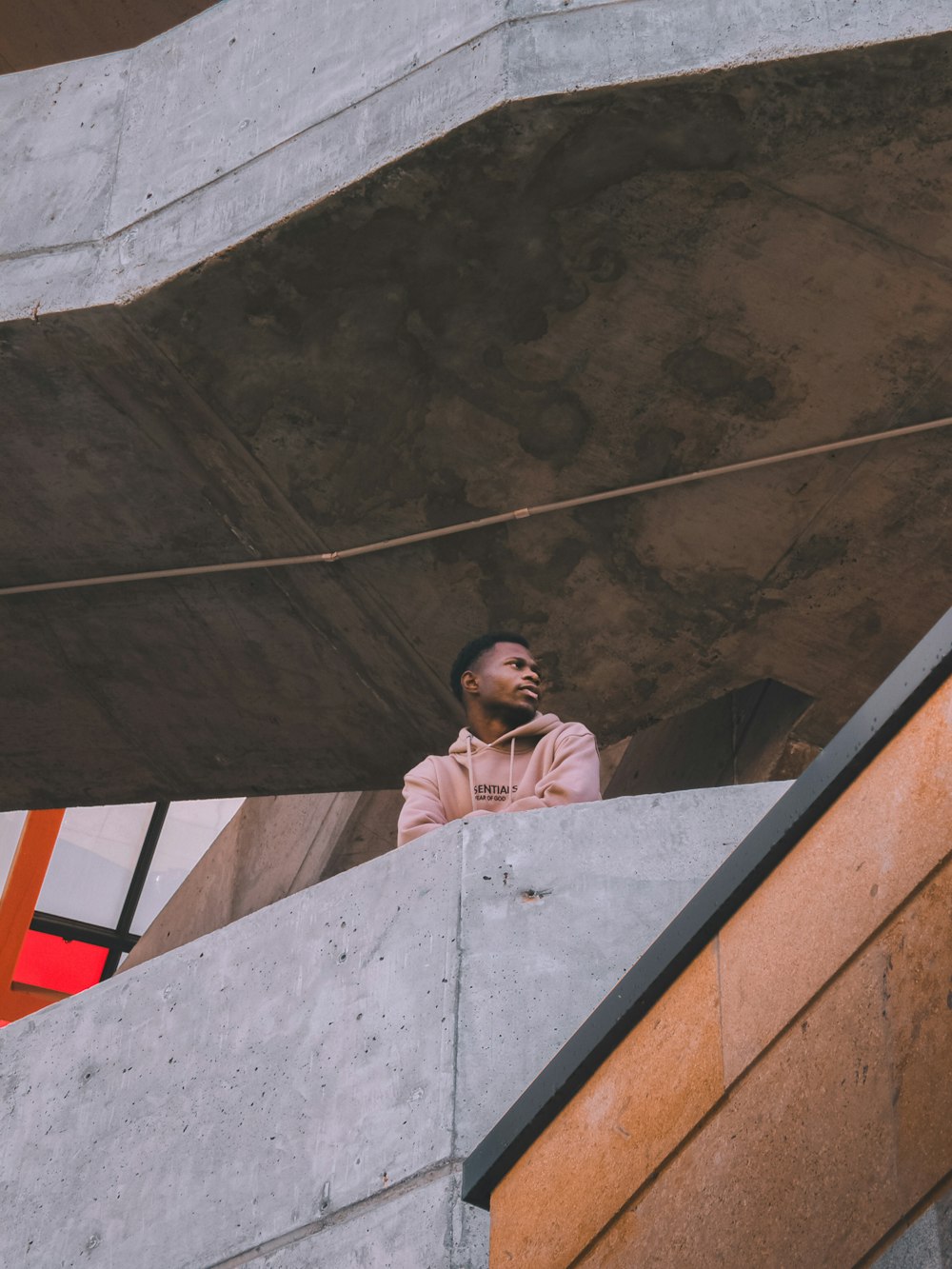 a man talking on a cell phone while standing on a ledge