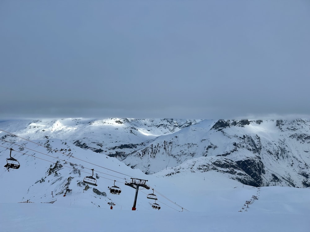 a ski lift going up a snowy mountain