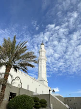 a tall white clock tower towering over a city