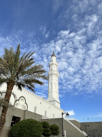 a tall white clock tower towering over a city
