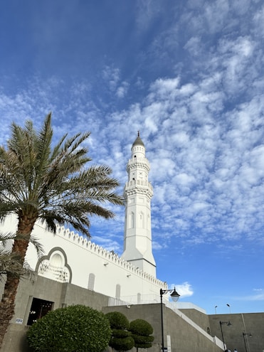 a tall white clock tower towering over a city
