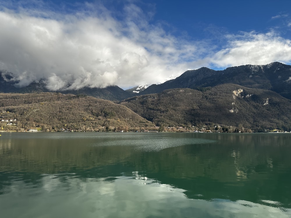 a body of water with mountains in the background