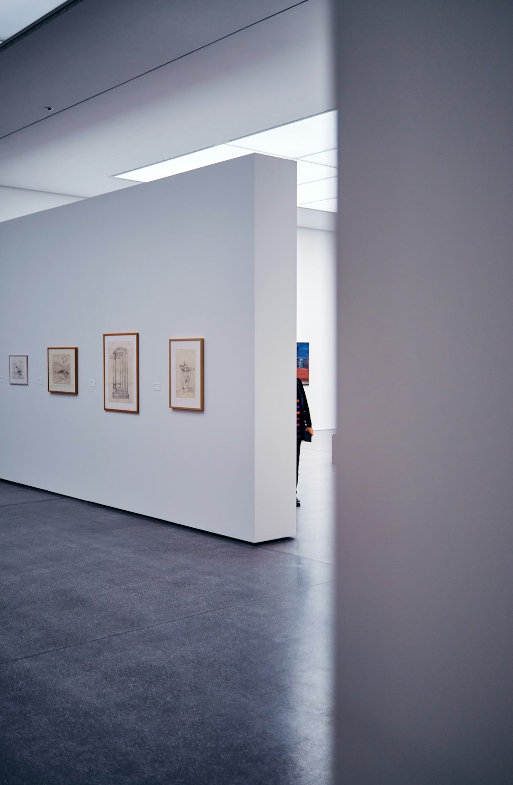 a white room with paintings on the wall
