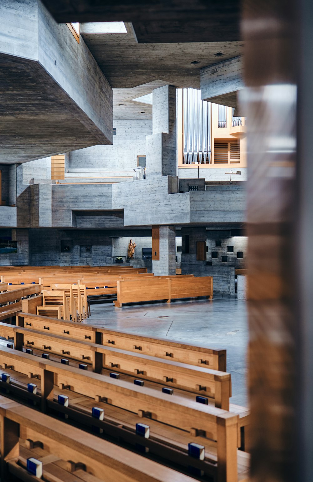 a church with wooden pews and a pipe