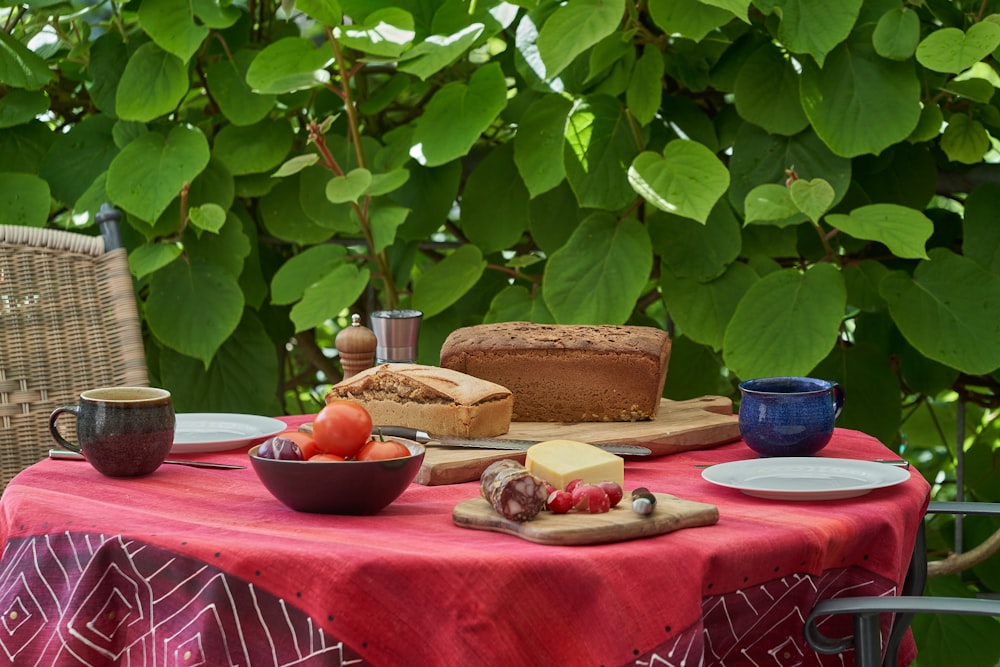 a table with a red table cloth and some food on it