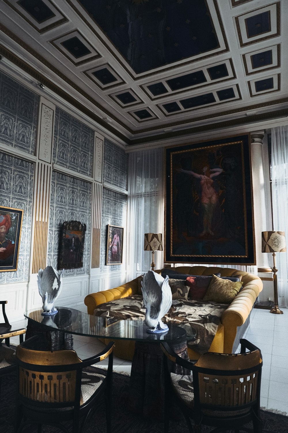 a living room filled with furniture and a painting on the wall