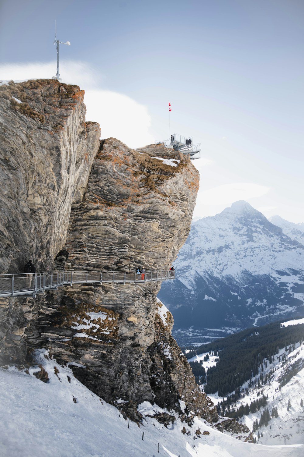 a man standing on top of a snow covered mountain