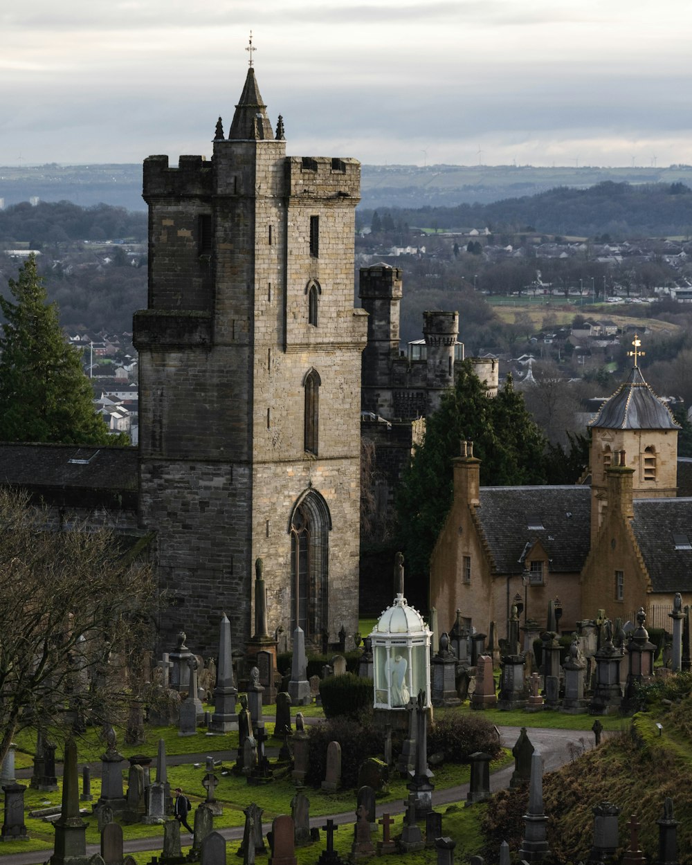 an old cemetery with a tower in the background