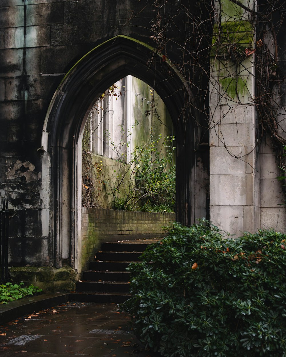 a stone archway with a set of steps leading to it