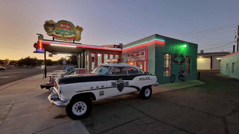 a police car parked in front of a gas station