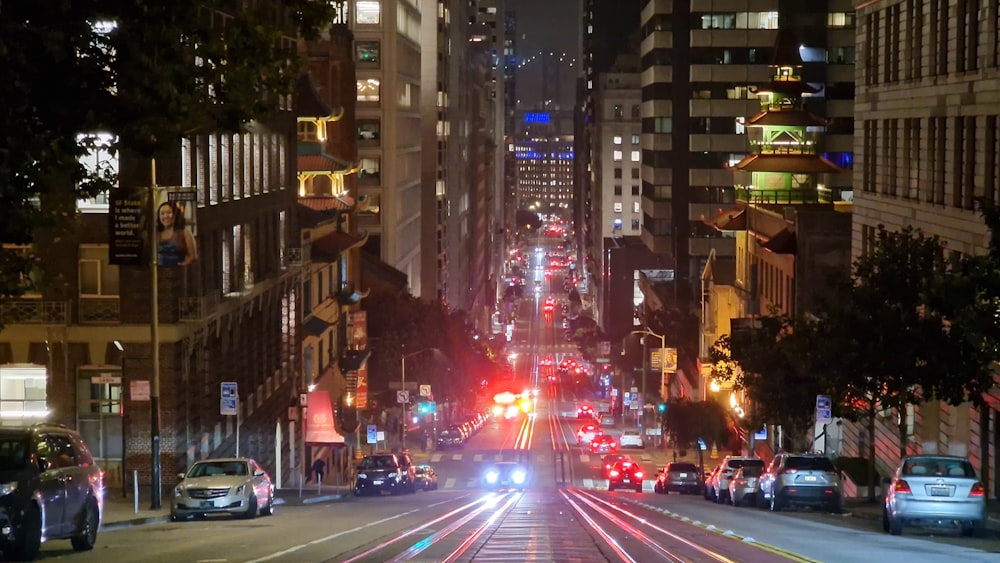 a city street filled with lots of traffic at night