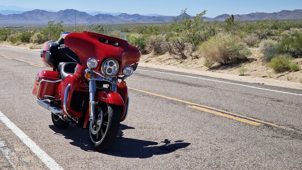 a red motorcycle parked on the side of the road