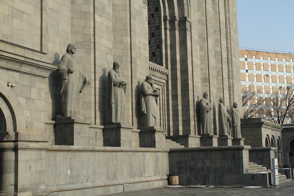 a large building with statues of people on it