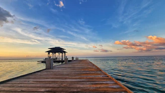 a wooden dock with a gazebo on the end of it