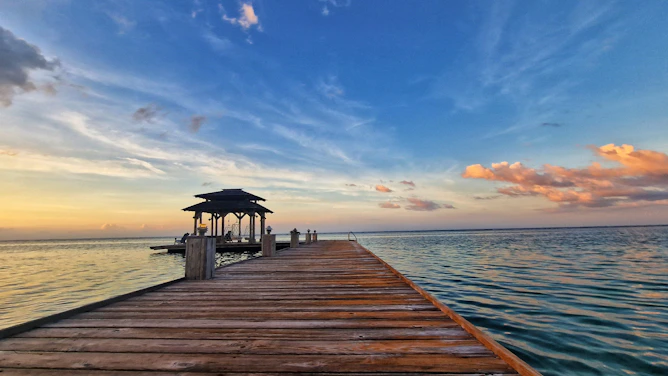 a wooden dock with a gazebo on the end of it