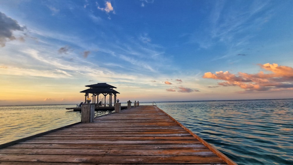 a wooden dock with a gazebo on the end of it