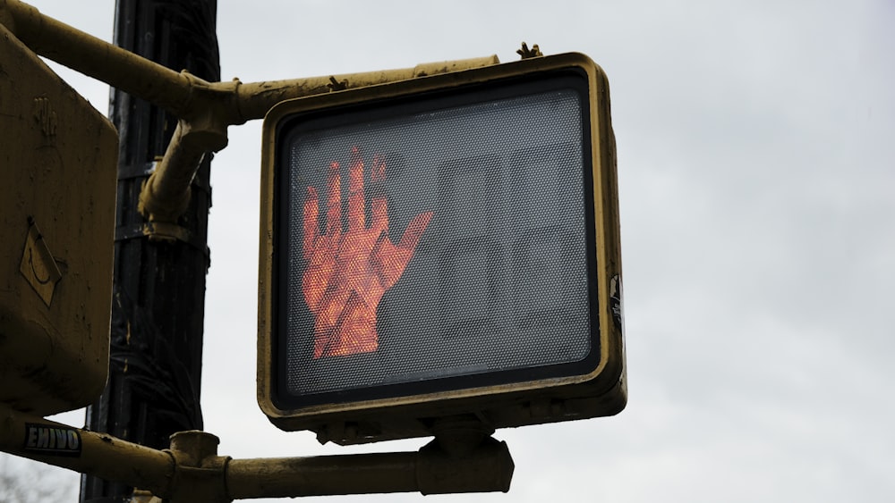 a traffic light with a red hand on it