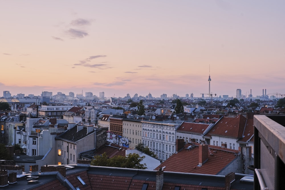 a view of a city at sunset from a rooftop