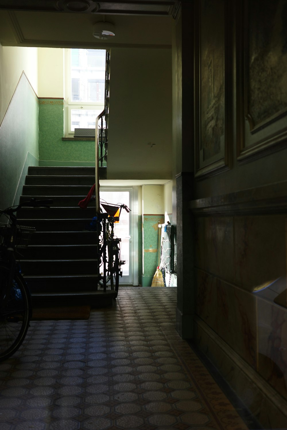 a bike is parked in a hallway next to a staircase