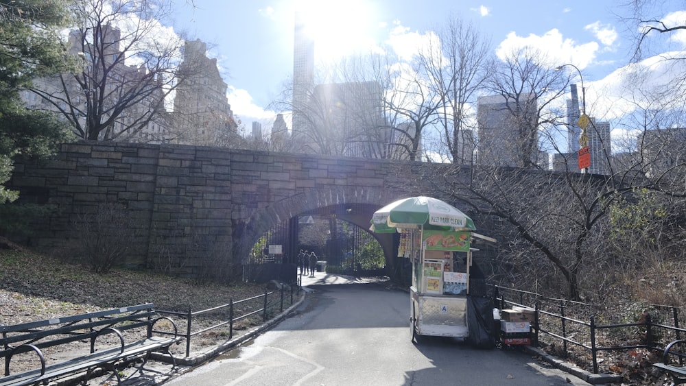 a bus driving down a street next to a bridge