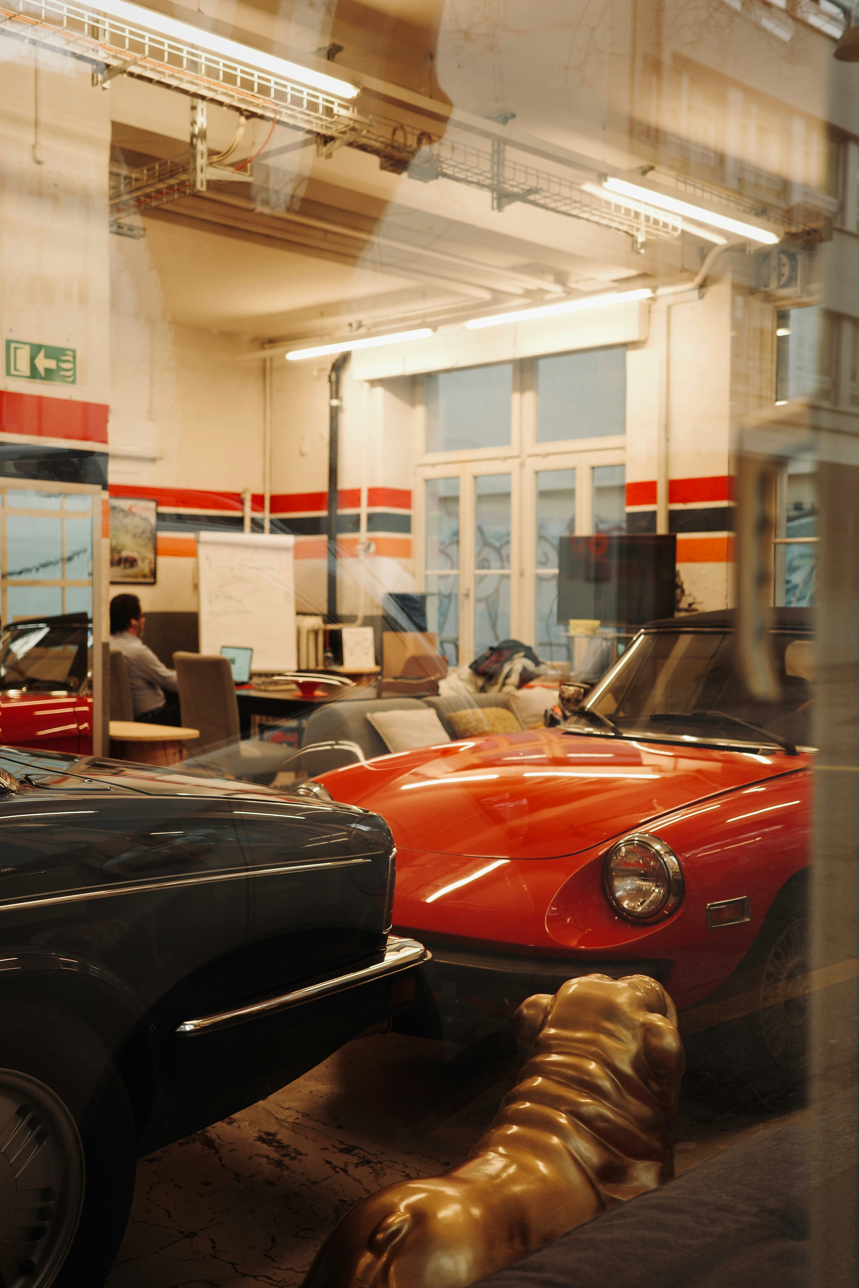 a group of cars parked inside of a garage